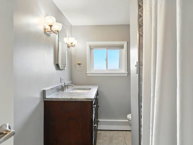 702/704 S Wilbur Ave, Sayre, PA 18840 - full bath featuring toilet, tile patterned floors, vanity, baseboard heating, and baseboards
