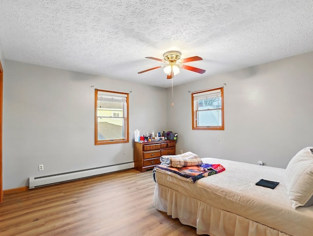 702/704 S Wilbur Ave, Sayre, PA 18840 - bedroom featuring baseboard heating, light wood-style flooring, a textured ceiling, ceiling fan, and baseboards