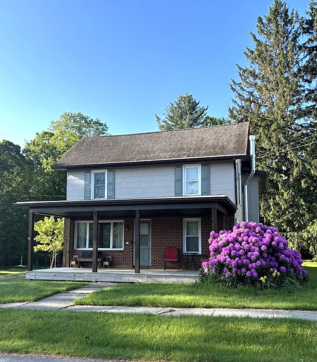 11 Conway St, Wellsboro, PA 16901 - view of front of house with a front lawn, covered porch, and brick siding