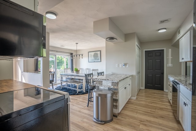 kitchen with pendant lighting, light hardwood / wood-style flooring, range with electric stovetop, light stone countertops, and white cabinetry