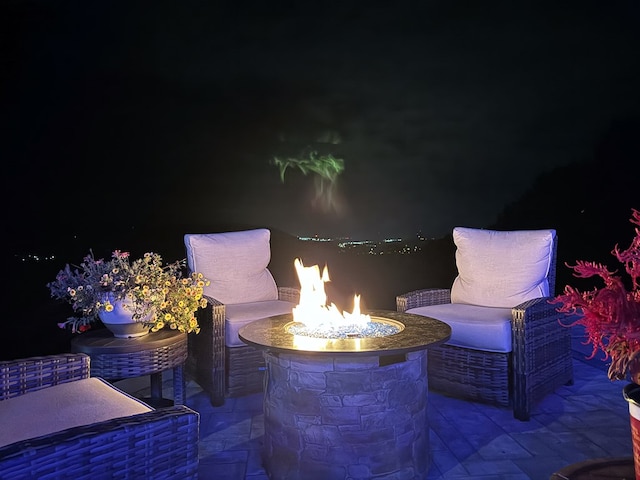 patio at twilight featuring an outdoor fire pit