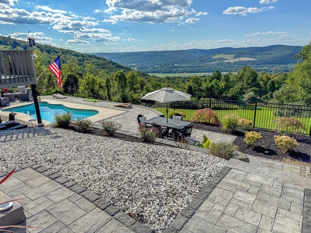 view of swimming pool featuring a mountain view and a patio