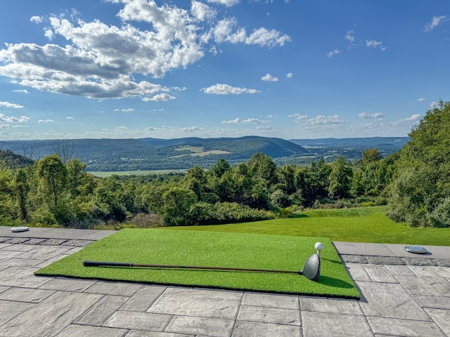 surrounding community featuring a lawn and a mountain view