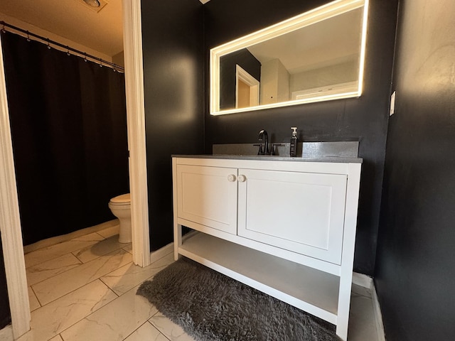 bathroom with vanity and toilet