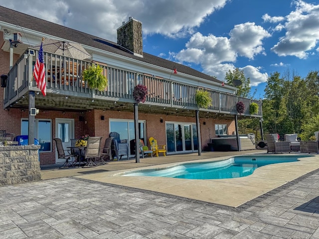 back of property featuring a patio and a balcony