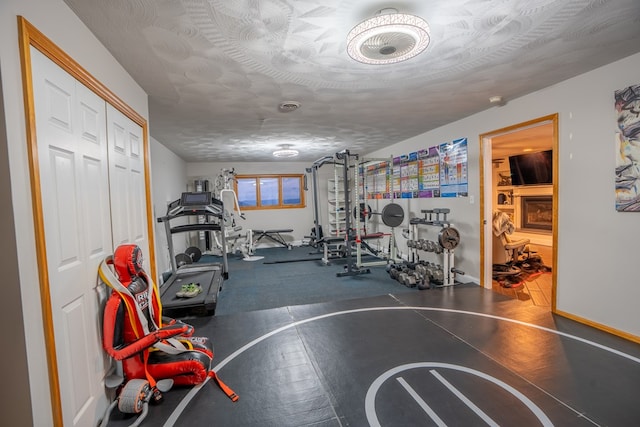 exercise room featuring a textured ceiling