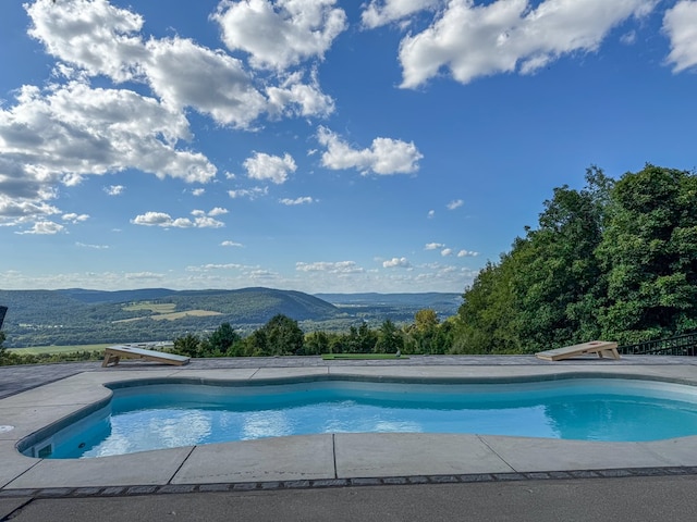 view of swimming pool with a mountain view