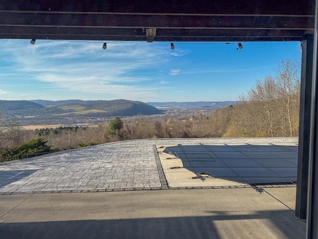 view of patio / terrace featuring a mountain view and a covered pool