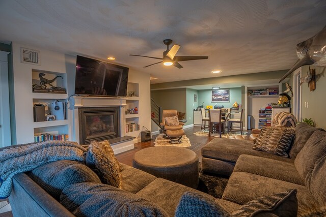 living room featuring ceiling fan and hardwood / wood-style flooring