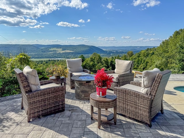 view of patio featuring a mountain view and a fire pit