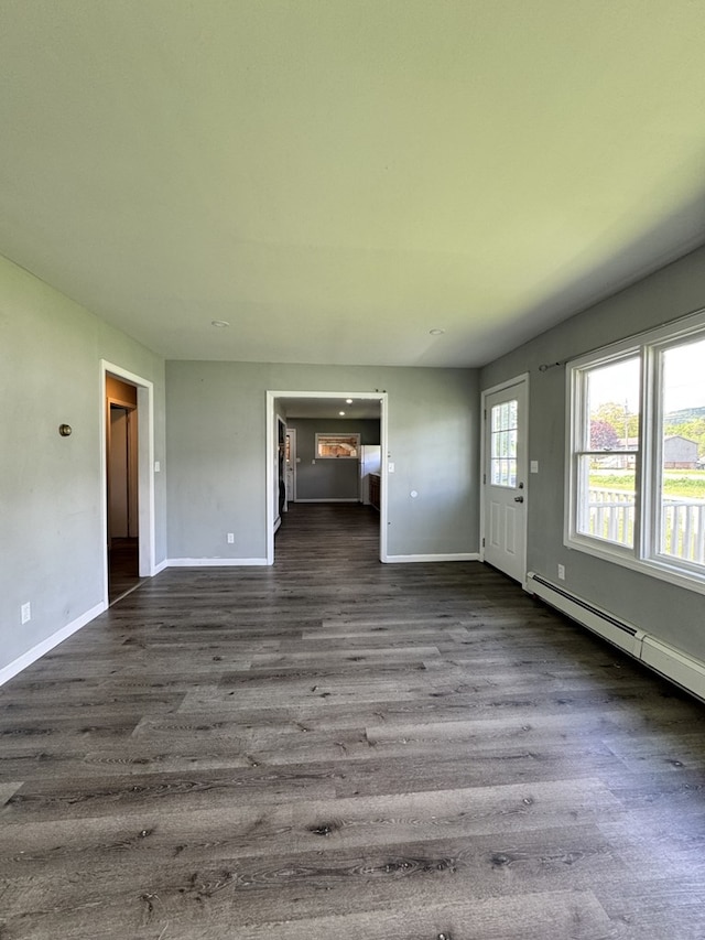 109 Main St, Roulette, PA 16746 - unfurnished living room featuring baseboards, dark wood-style floors, and a baseboard heating unit