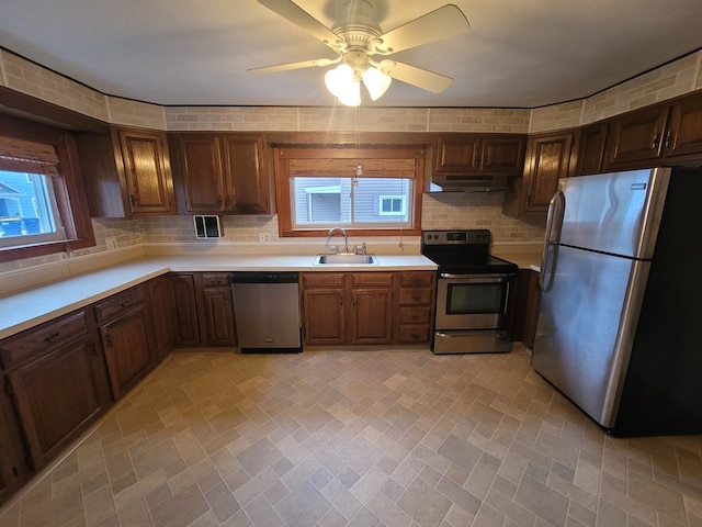 kitchen featuring appliances with stainless steel finishes, ceiling fan, a healthy amount of sunlight, and sink