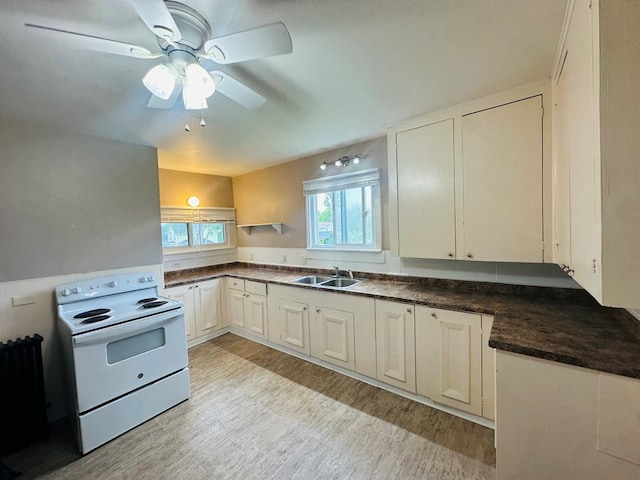 228 Willow St, Athens, PA 18810 - kitchen featuring electric range, a sink, dark countertops, light wood-type flooring, and a ceiling fan