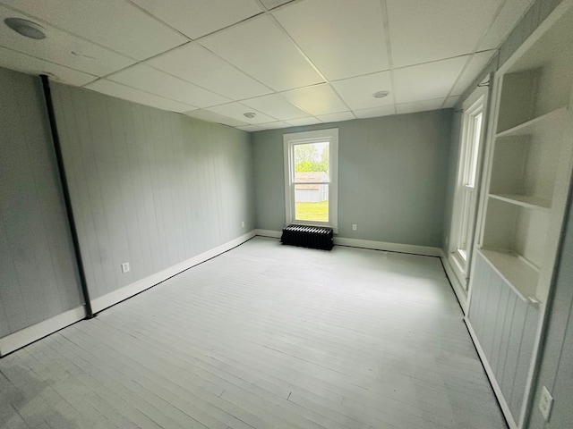 228 Willow St, Athens, PA 18810 - empty room featuring baseboards, a drop ceiling, and wood finished floors