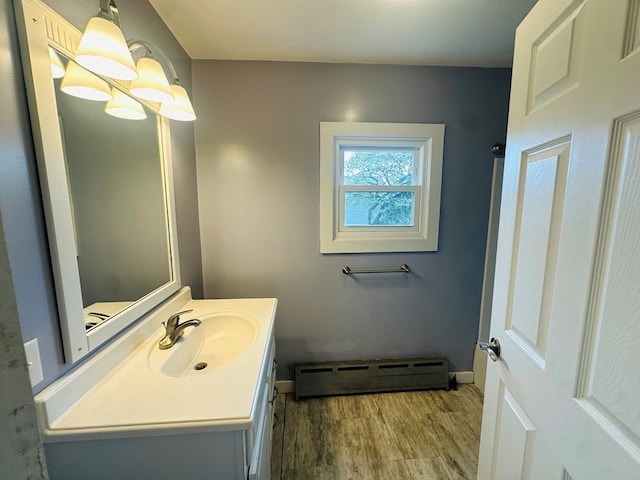 228 Willow St, Athens, PA 18810 - bathroom with a baseboard radiator, wood finished floors, baseboards, and vanity