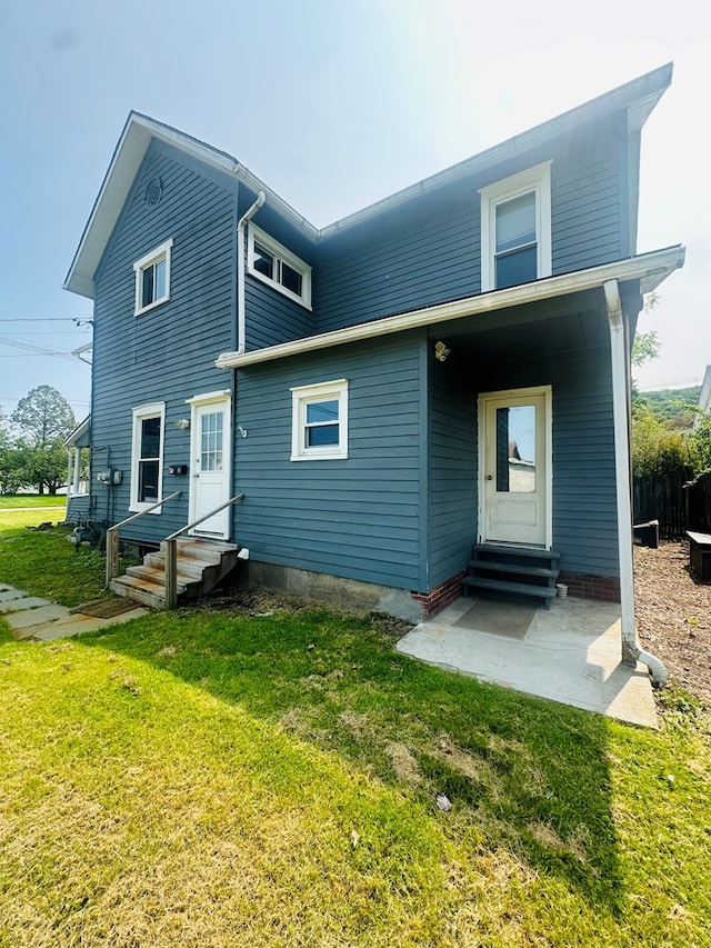 228 Willow St, Athens, PA 18810 - rear view of house featuring entry steps, a lawn, and a patio