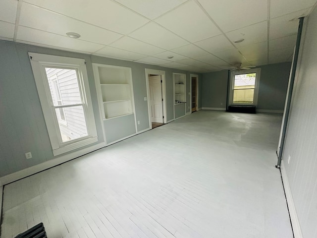 228 Willow St, Athens, PA 18810 - empty room featuring built in features, baseboards, and a paneled ceiling