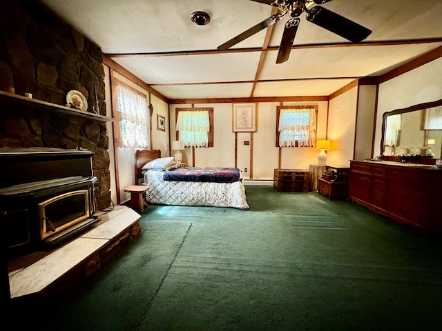 carpeted bedroom featuring ceiling fan and a baseboard heating unit