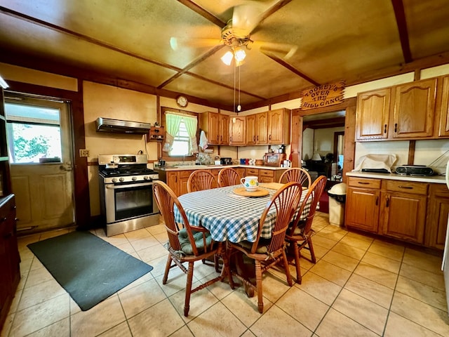 kitchen with ceiling fan, light tile patterned floors, range hood, and stainless steel range