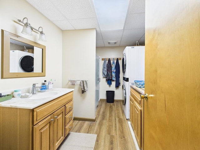 40 W Hebron Rd, Coudersport, PA 16915 - full bathroom featuring stacked washing machine and dryer, a drop ceiling, vanity, wood finished floors, and a shower