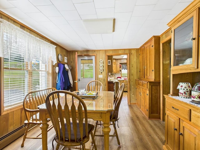 40 W Hebron Rd, Coudersport, PA 16915 - dining area with light wood finished floors, baseboard heating, and wood walls