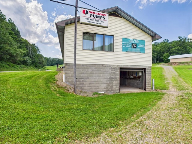 40 W Hebron Rd, Coudersport, PA 16915 - view of side of property with dirt driveway, a lawn, and an attached garage
