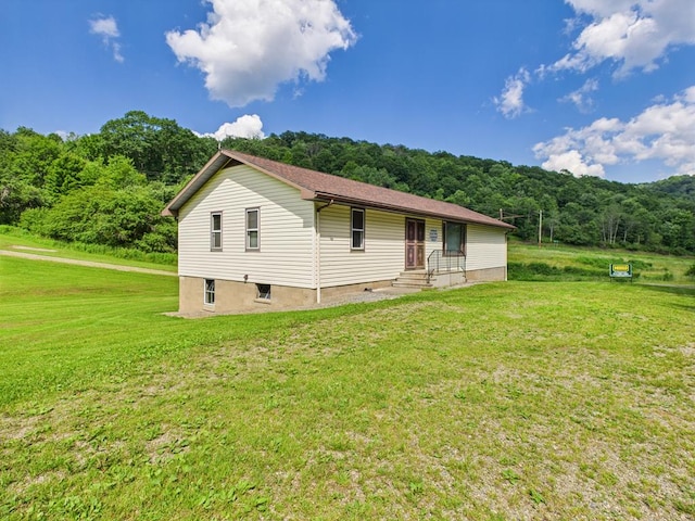40 W Hebron Rd, Coudersport, PA 16915 - view of side of property with a lawn and a view of trees