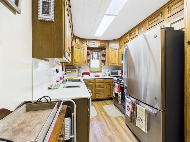 40 W Hebron Rd, Coudersport, PA 16915 - kitchen with stainless steel appliances, open shelves, brown cabinets, light countertops, and light wood-style floors