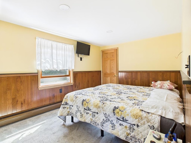 40 W Hebron Rd, Coudersport, PA 16915 - bedroom with a wainscoted wall, baseboard heating, wood walls, and carpet floors