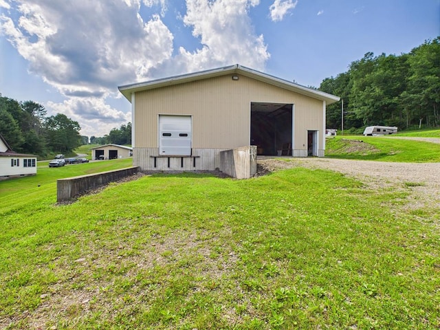 40 W Hebron Rd, Coudersport, PA 16915 - view of property exterior featuring a yard, an outdoor structure, an outbuilding, driveway, and a garage