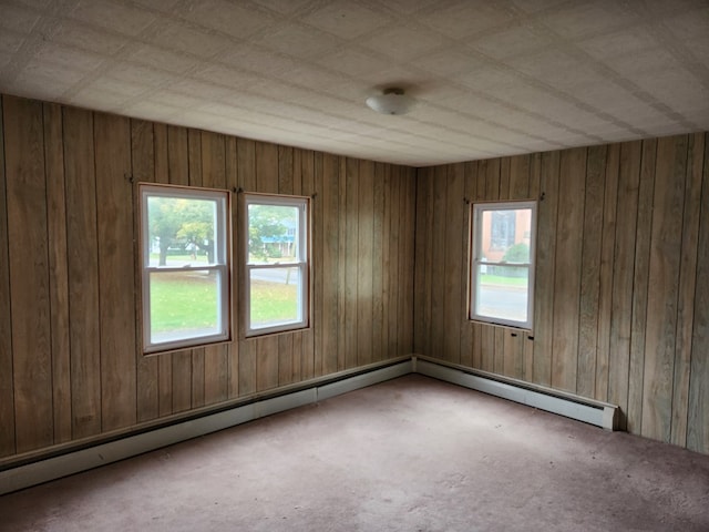 unfurnished room featuring carpet floors and a baseboard radiator