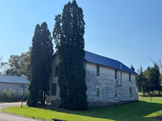 view of property exterior featuring a yard