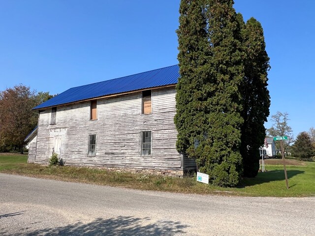 view of side of home featuring a lawn