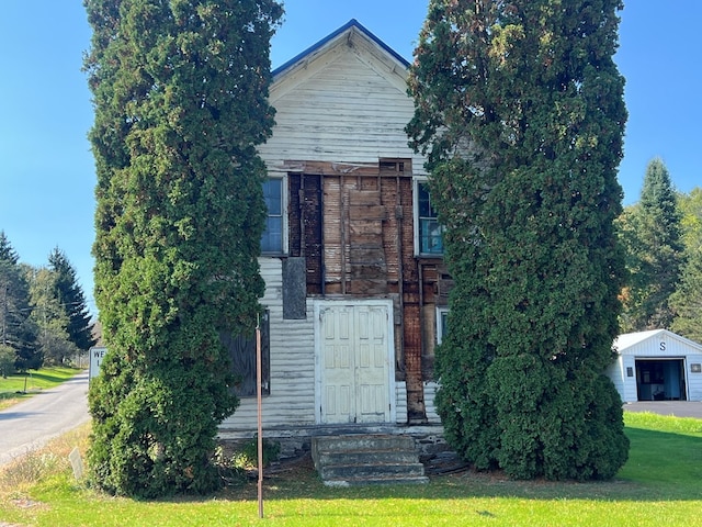 view of front of property with an outbuilding and a front yard