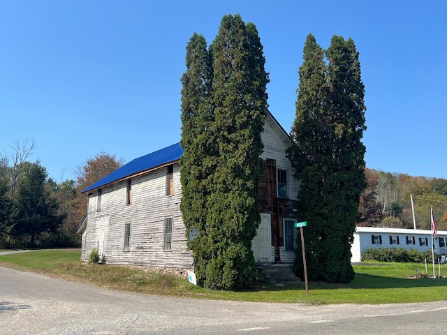 view of home's exterior with a yard