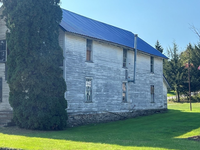 view of property exterior featuring a lawn