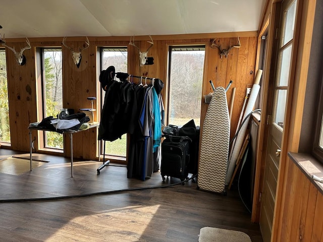 interior space with wood walls and dark wood-type flooring