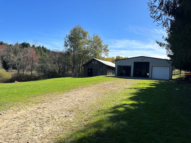 view of yard featuring an outbuilding and a garage