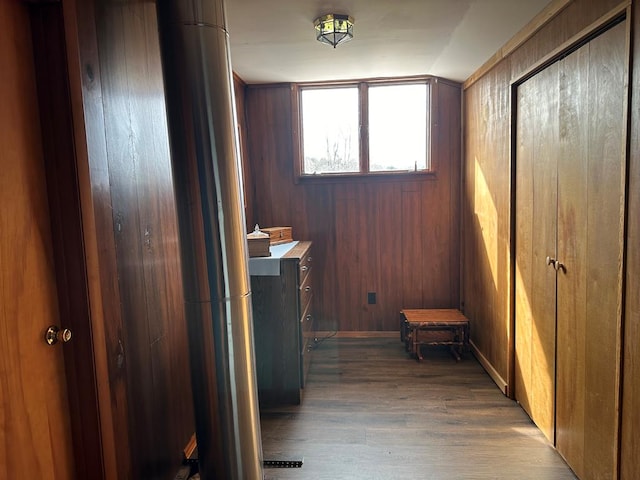 hall with wood walls and light wood-type flooring