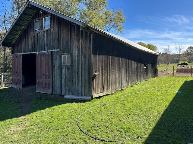 view of outbuilding featuring a yard