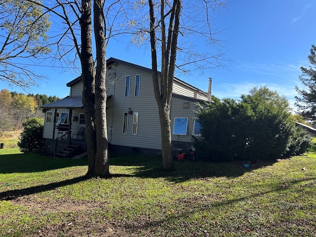 view of property exterior with a lawn