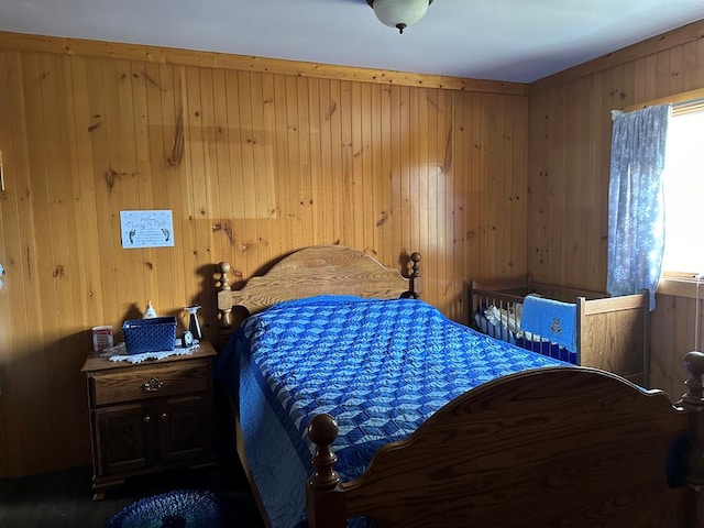 bedroom featuring wooden walls