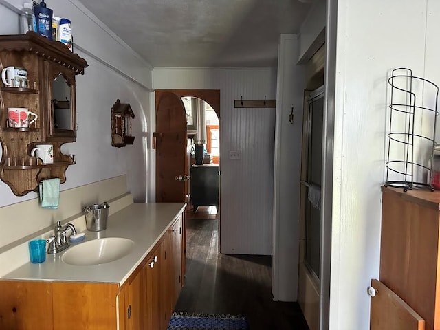 bathroom featuring vanity, hardwood / wood-style flooring, and a shower with shower door