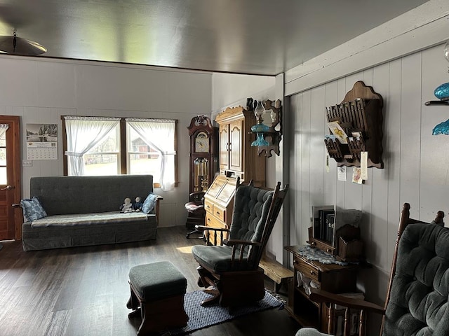 living room featuring wood-type flooring and wooden walls