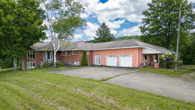 ranch-style home with a front yard and a garage