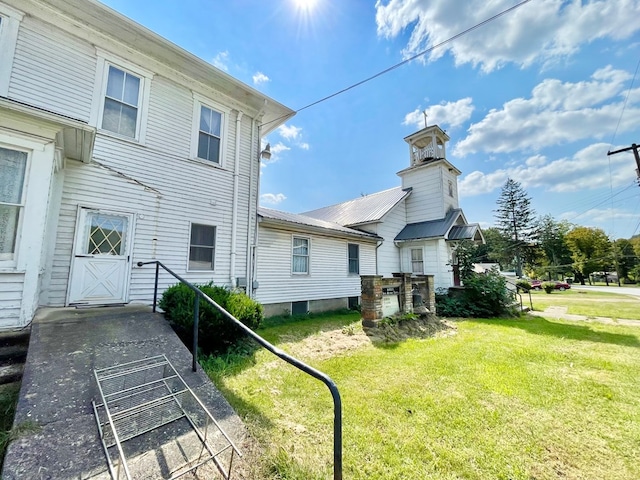 view of property exterior with a lawn