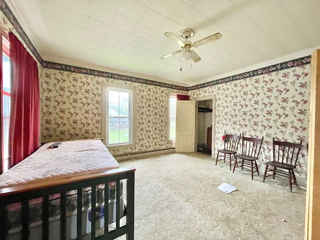 bedroom with a baseboard radiator and ceiling fan