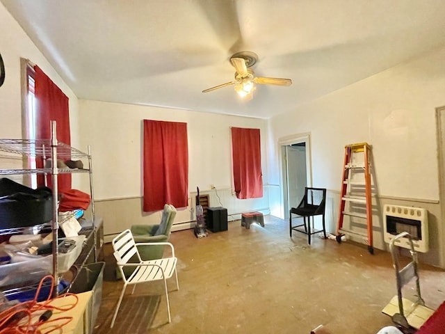 interior space with ceiling fan, concrete flooring, baseboard heating, and heating unit