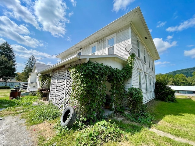 view of side of home with a lawn