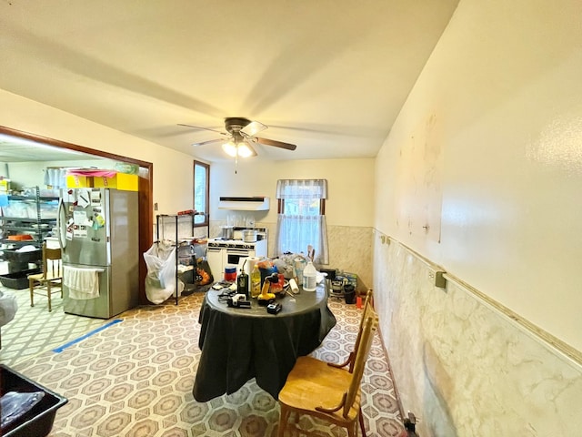 interior space with ceiling fan and stainless steel fridge